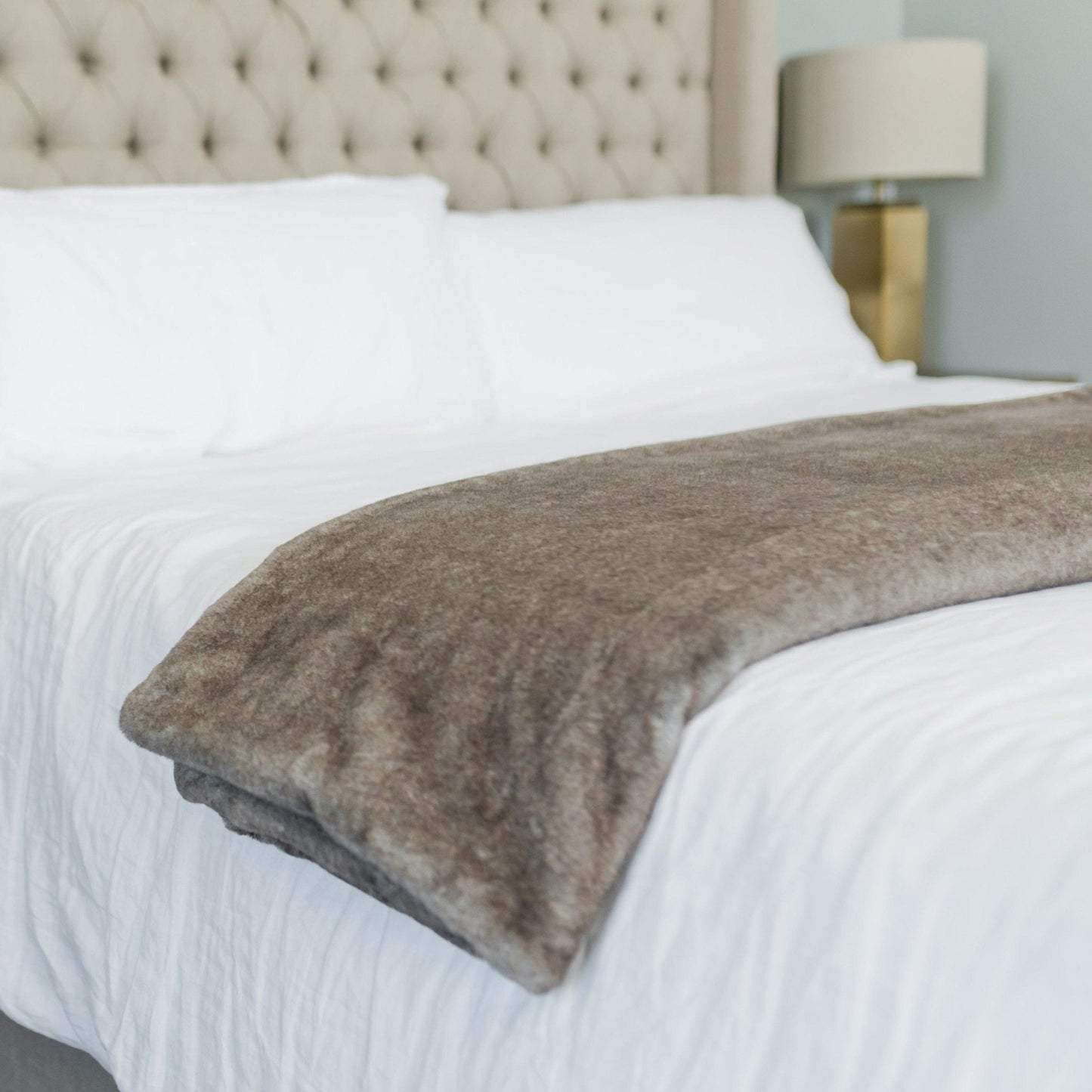 XL Grand Saranoni blanket draped over bed.