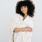 Woman wrapped in a neutral floral printed minky stretch XL blanket. 