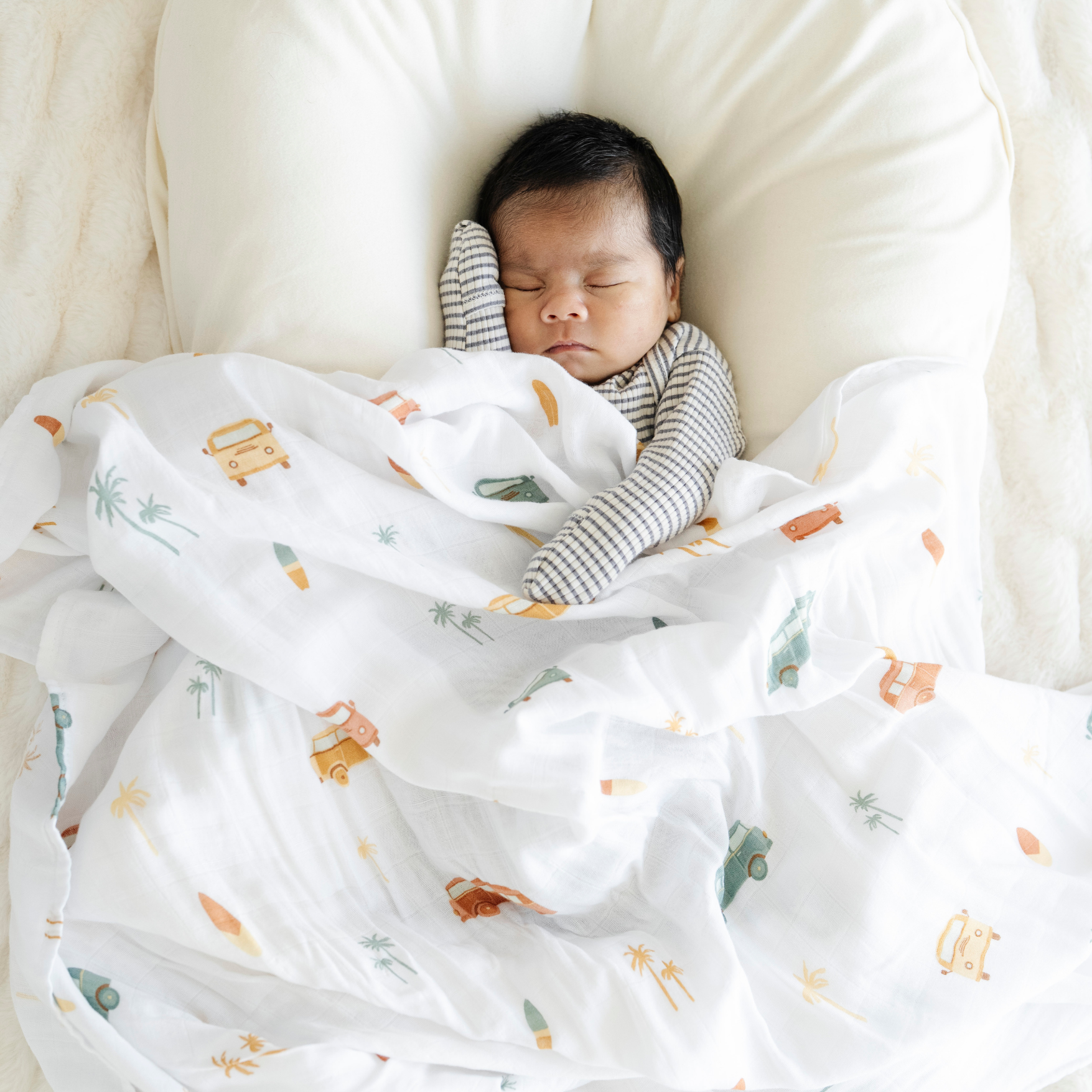 Baby boy with Van Life Bamboo Rayon Muslin Saranoni soft swaddle.