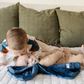 Two little boys and a mini blanket that is a navy blanket. The soft blanket is a lush blanket and a baby blanket as well as a Saranoni blanket. This cozy blanket is a luxury blanket for babies and is so soft.