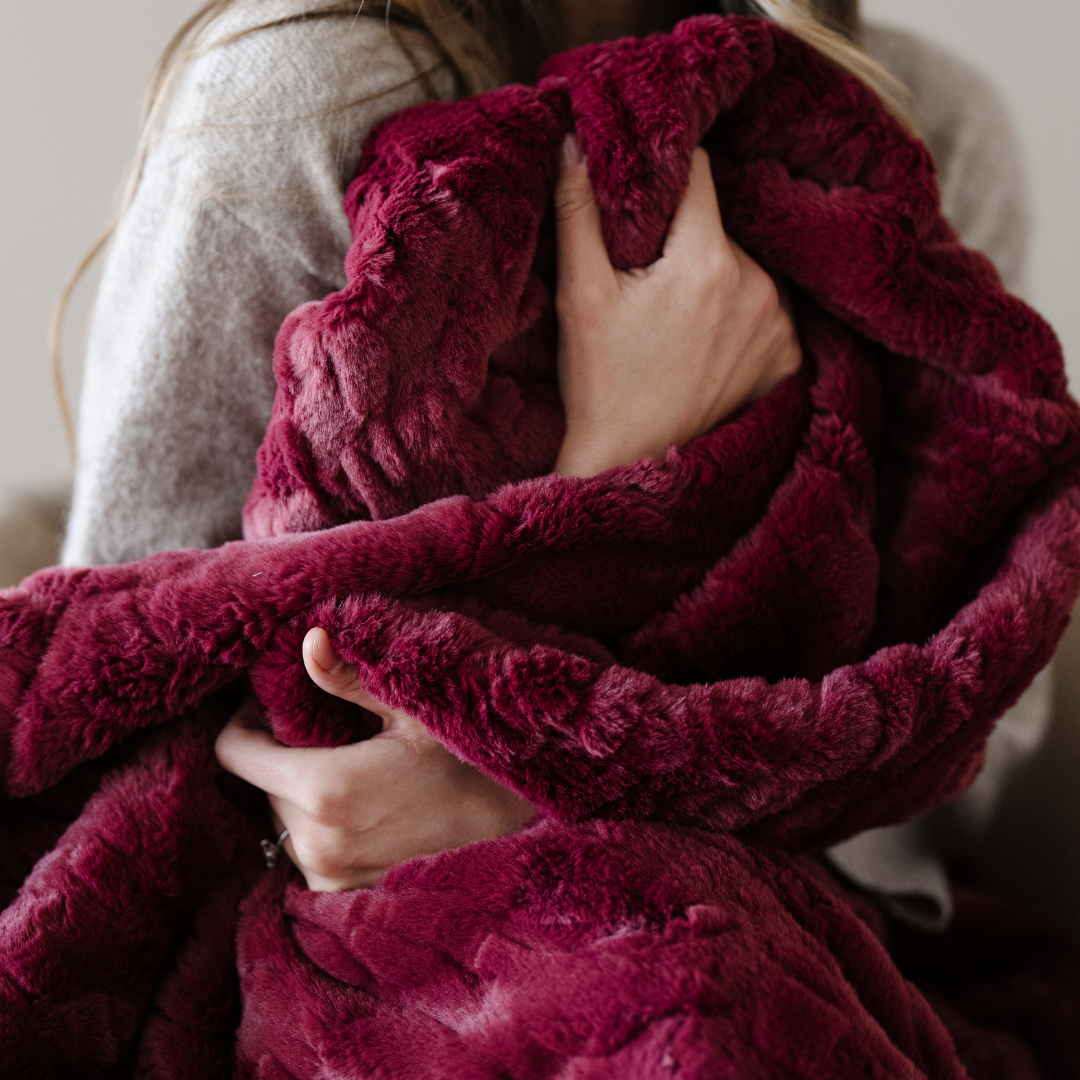 Add a touch of elegance to your home with this deep red patterned faux fur blanket from Saranoni. This soft blanket features a luxurious texture and adds a cozy aesthetic. Enjoy this durable throw blanket for years to come!