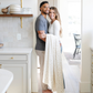 A husband and wife with a floral minky stretch blanket. This soft blanket is a Saranoni blanket and is very durable and stretchy. This cozy blanket is perfect for gifting, lounging, and on the go. 