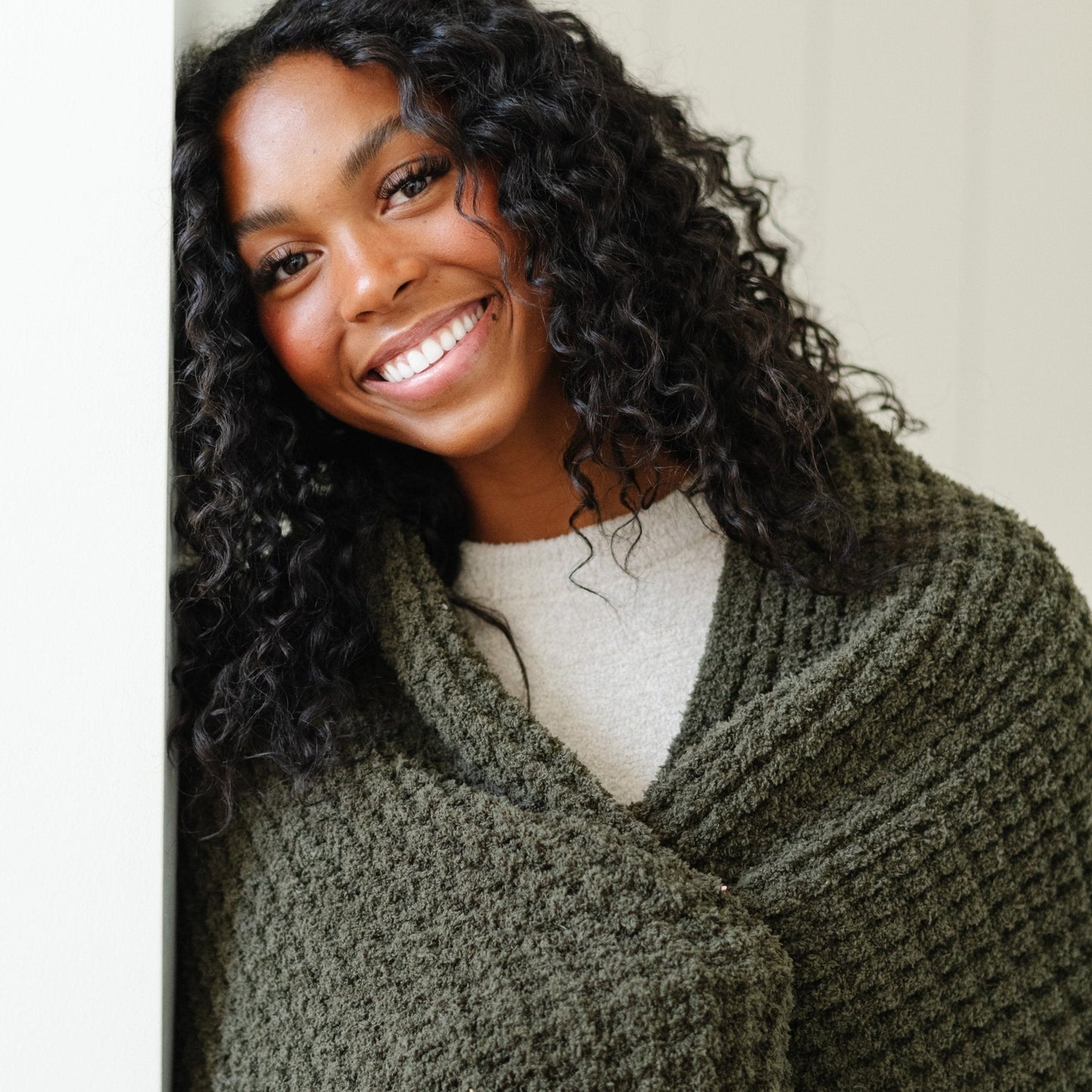 Detailed shot showing texture of an extra large green waffle knit blanket.